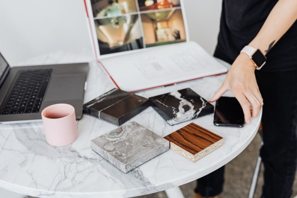 Interior design planning with material samples on a marble table, the work behind interior designer cost in Cairo