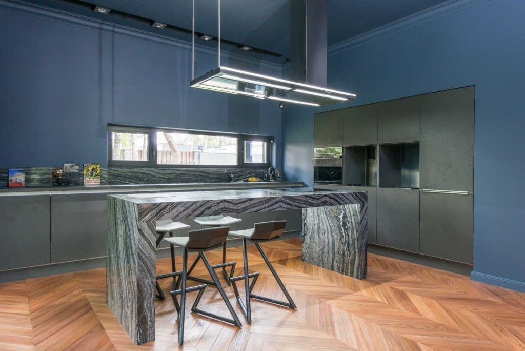 Interior design timeline in Cairo -- deep blue kitchen with a stone island and integrated lighting