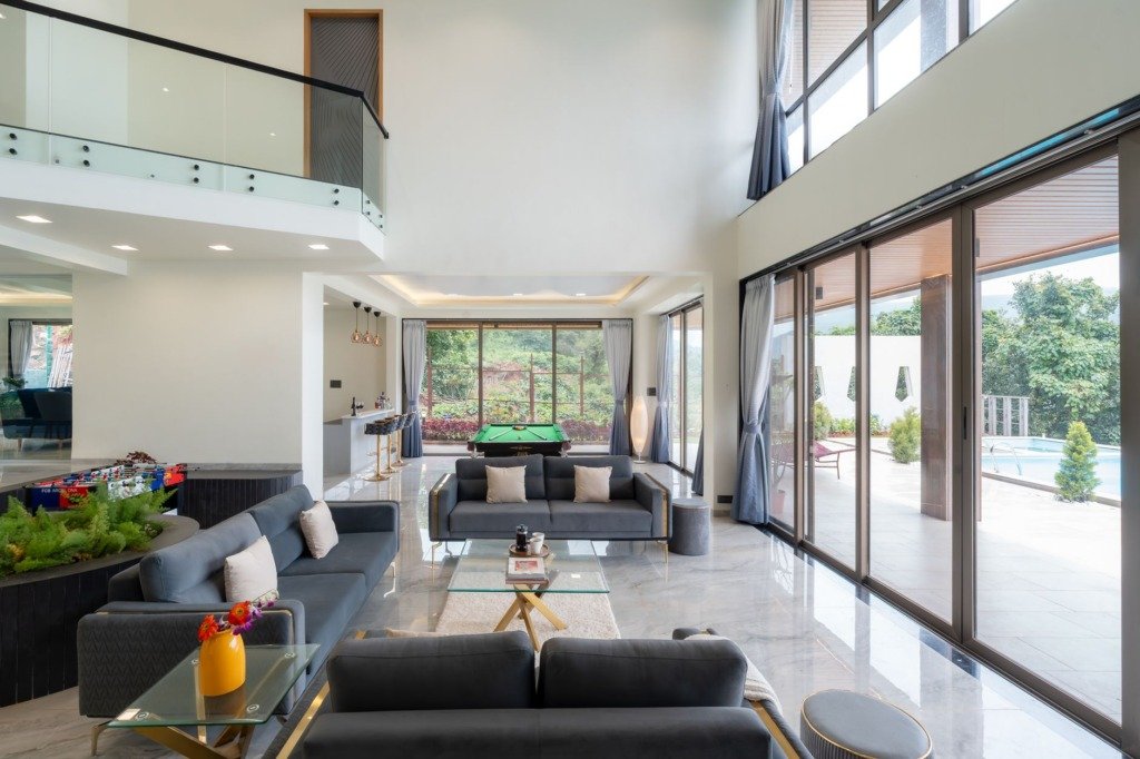 Double height villa living room with full height glazing