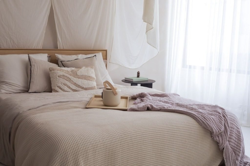 Calm bedroom in warm neutrals with linen bedding