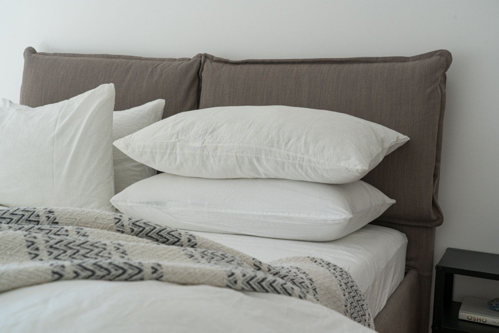 Modern bedroom featuring clean white bedding and pillows for a cozy and inviting atmosphere, choosing a bed and mattress in Cairo