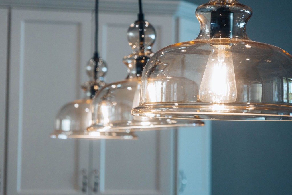 Close-up of stylish glass pendant lamps illuminating a modern indoor space, choosing a chandelier for a Cairo home